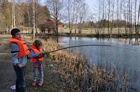 Pastor providing fishing equipment to children